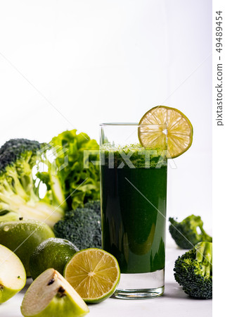 Green smoothie with apple and lemon on white wooden background. Raw food and drink. Copy space 49489454