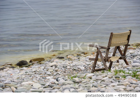 old wooden foldable chair at the beach old wooden foldable chair at the beach 49490168