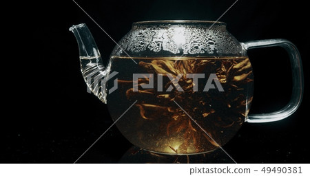 Blooming tea in a glass teapot Blooming tea in a glass teapot 49490381