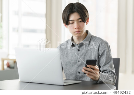 Freelance engineer checking smartphone 49492422