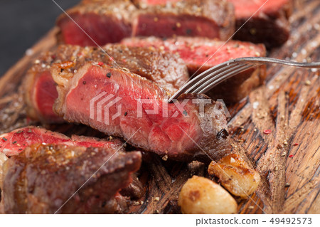 Closeup ready to eat steak new York. Closeup ready to eat steak new York. 49492573