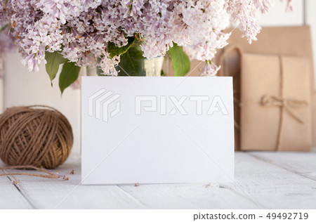 Blank white greeting card with lilac flowers. 49492719