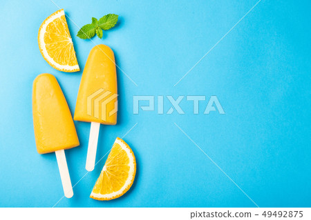 Orange popsicles with juice. 49492875