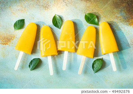 Orange popsicles with juice. 49492876
