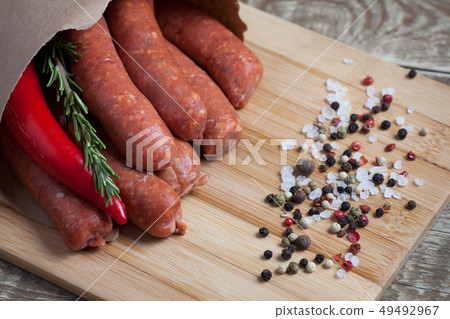 Raw homemade sausages. 49492967