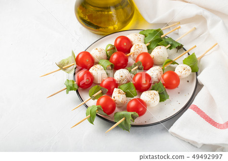 skewer with tomato, mozzarella and basil. skewer with tomato, mozzarella and basil. 49492997