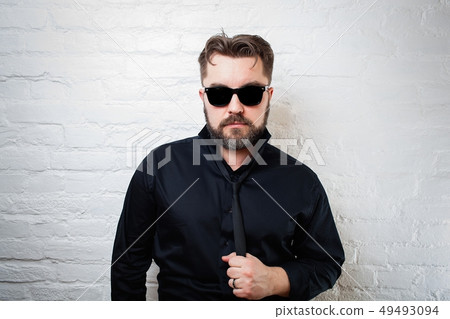 Portrait of a bearded serious man in sunglasses. Portrait of a bearded serious man in sunglasses. 49493094