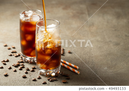 Ice coffee in a tall glass. Ice coffee in a tall glass. 49493133