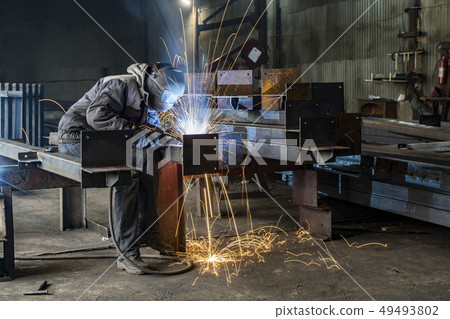Welding with sparks by Process fluxed cored arc welding ,Industrial steel welder part in factory 49493802