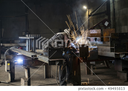 Welding with sparks by Process fluxed cored arc welding ,Industrial steel welder part in factory Welding with sparks by Process fluxed cored arc welding ,Industrial steel welder part in factory 49493813