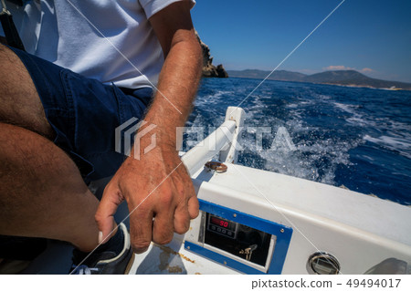 Man drive motor boat in the sea. 49494017
