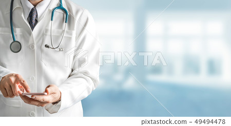 Male doctor using mobile phone at hospital. 49494478