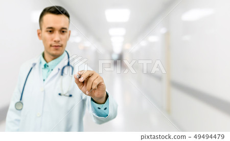 Doctor pointing pen at empty space for your text. Doctor pointing pen at empty space for your text. 49494479