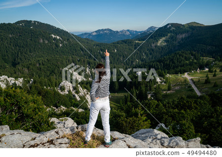 Woman traveler hiking across Croatia landscape. Woman traveler hiking across Croatia landscape. 49494480