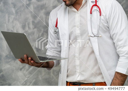 Doctor using laptop computer at the hospital. Doctor using laptop computer at the hospital. 49494777