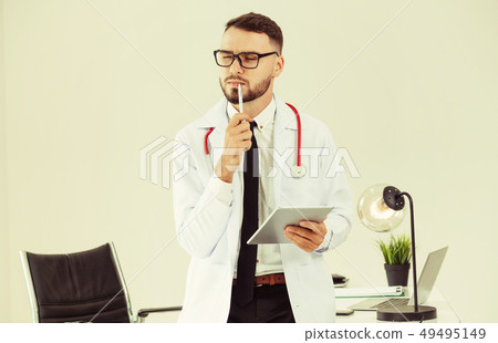 Doctor working on tablet computer in the hospital. 49495149