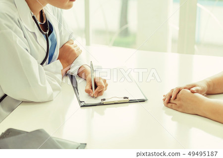 Woman Doctor and Female Patient in Hospital Office Woman Doctor and Female Patient in Hospital Office 49495187