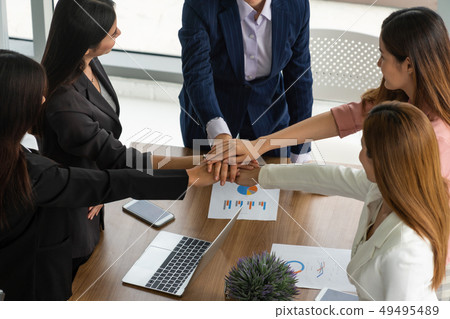 Teamwork businesswomen joining hands in meeting. Teamwork businesswomen joining hands in meeting. 49495489