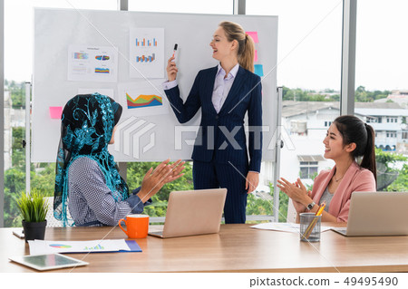 Multicultural working group in teamwork meeting. 49495490