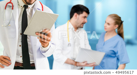 Doctor working in hospital with other doctors. Doctor working in hospital with other doctors. 49495617