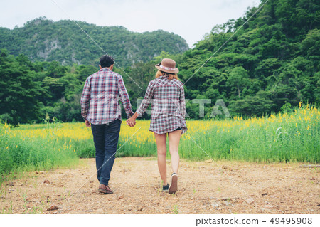 Happy couple take a romantic walk on the hills. Happy couple take a romantic walk on the hills. 49495908