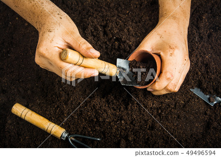 Gardening equipment and hand with soil Gardening equipment and hand with soil 49496594