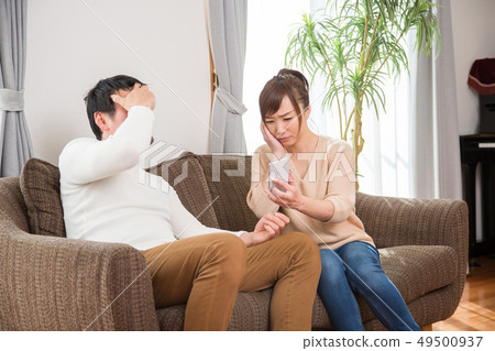Married couple looking at a smartphone Married couple looking at a smartphone 49500937