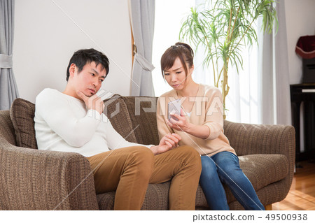 Married couple looking at a smartphone 49500938
