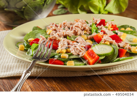 Fresh spinach salad with tuna, cucumber, corn, and 49504034