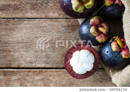 mangosteen in gunny sack on wood table mangosteen in gunny sack on wood table 49504134