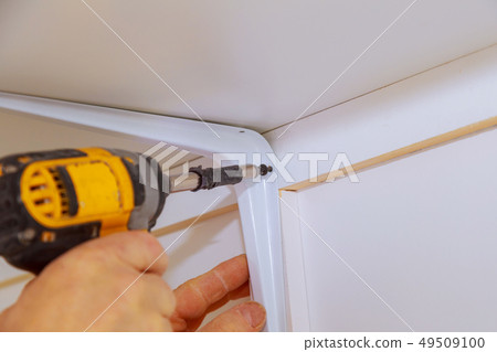 Profile view of a good looking handyman making 49509100