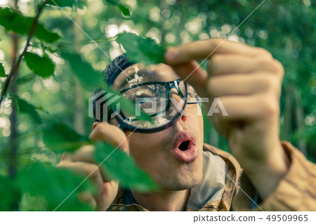 Photo of young ecologist with magnifying glass 49509965