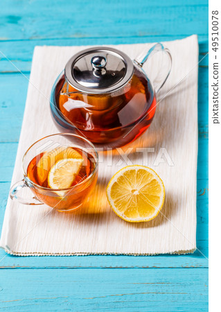 Glass cup of tea with lemon and glass teapot. Glass cup of tea with lemon and glass teapot. 49510078