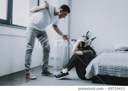 Husband Hold Kitchen Knife. Wife Sits on Floor. 49510453