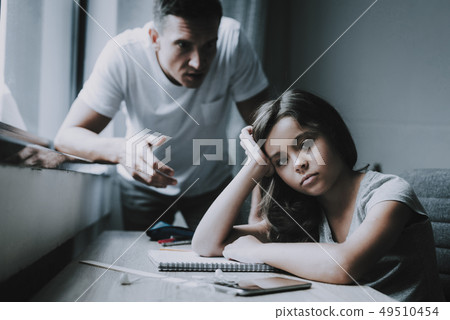 Little Girl Stares Indifferently. Father Angers at 49510454