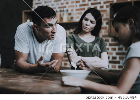 Father Rebukes Daughter. Sad Girl is Sit at Table. 49510484
