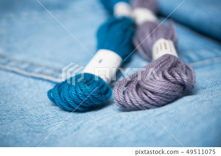 closeup of blue cotton threads on blue jeans closeup of blue cotton threads on blue jeans 49511075