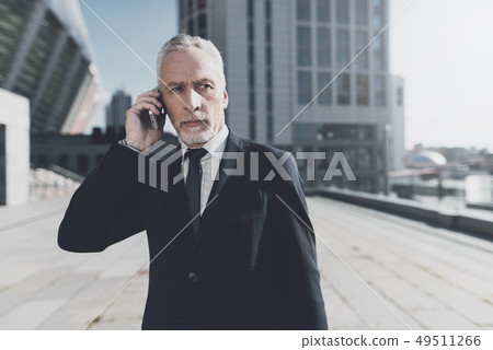 Businessman is Talking on Mobile Phone Businessman is Talking on Mobile Phone 49511266