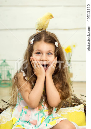 A scared little girl has a cute fluffy Easter A scared little girl has a cute fluffy Easter 49513320