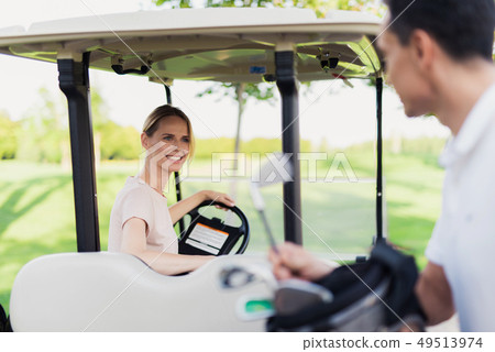 Golf Player Teeing the Ball Squatting on a Turf. Golf Player Teeing the Ball Squatting on a Turf. 49513974