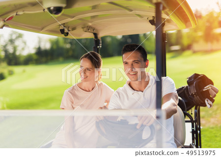 Golf Player Teeing the Ball Squatting on a Turf. Golf Player Teeing the Ball Squatting on a Turf. 49513975