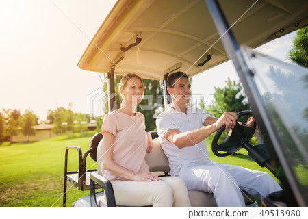 Golf Player Teeing the Ball Squatting on a Turf. Golf Player Teeing the Ball Squatting on a Turf. 49513980