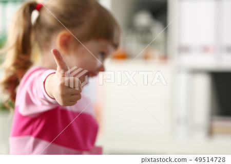 Little girl show approve or OK sign with her arm Little girl show approve or OK sign with her arm 49514728
