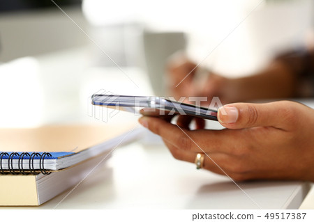 Arm of black woman hold silver pen workplace writing something Arm of black woman hold silver pen workplace writing something 49517387