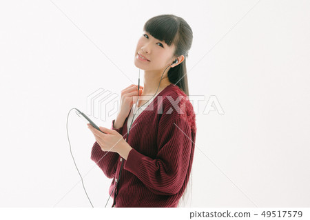 A woman listening to music 49517579