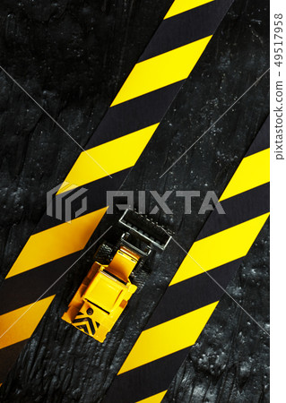 Yellow toy bulldozer on a black background 49517958