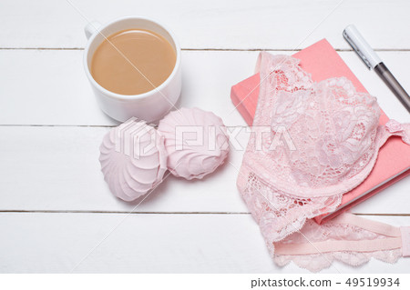 Cup of coffee with marshmallows. Pink lace bodice 49519934