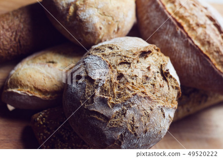 different types of bread on wooden kitchen cutting 49520222