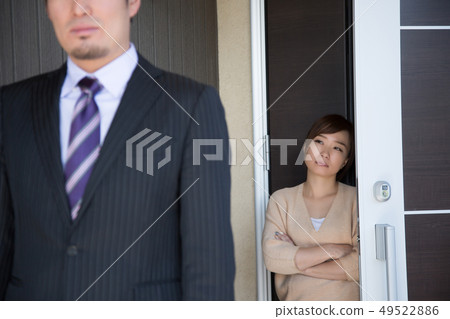 Wife sending out her husband at the entrance 49522886