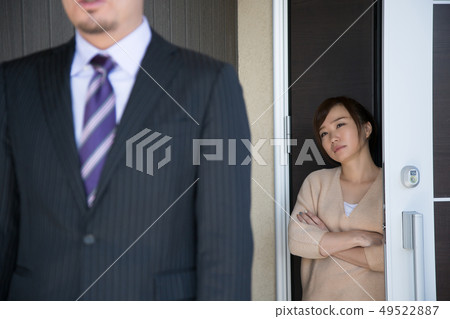 Wife sending out her husband at the entrance Wife sending out her husband at the entrance 49522887
